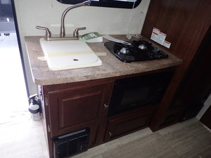 Kitchenette inside the 2018 Palomino Bunkhouse travel trailer for rent in michigan